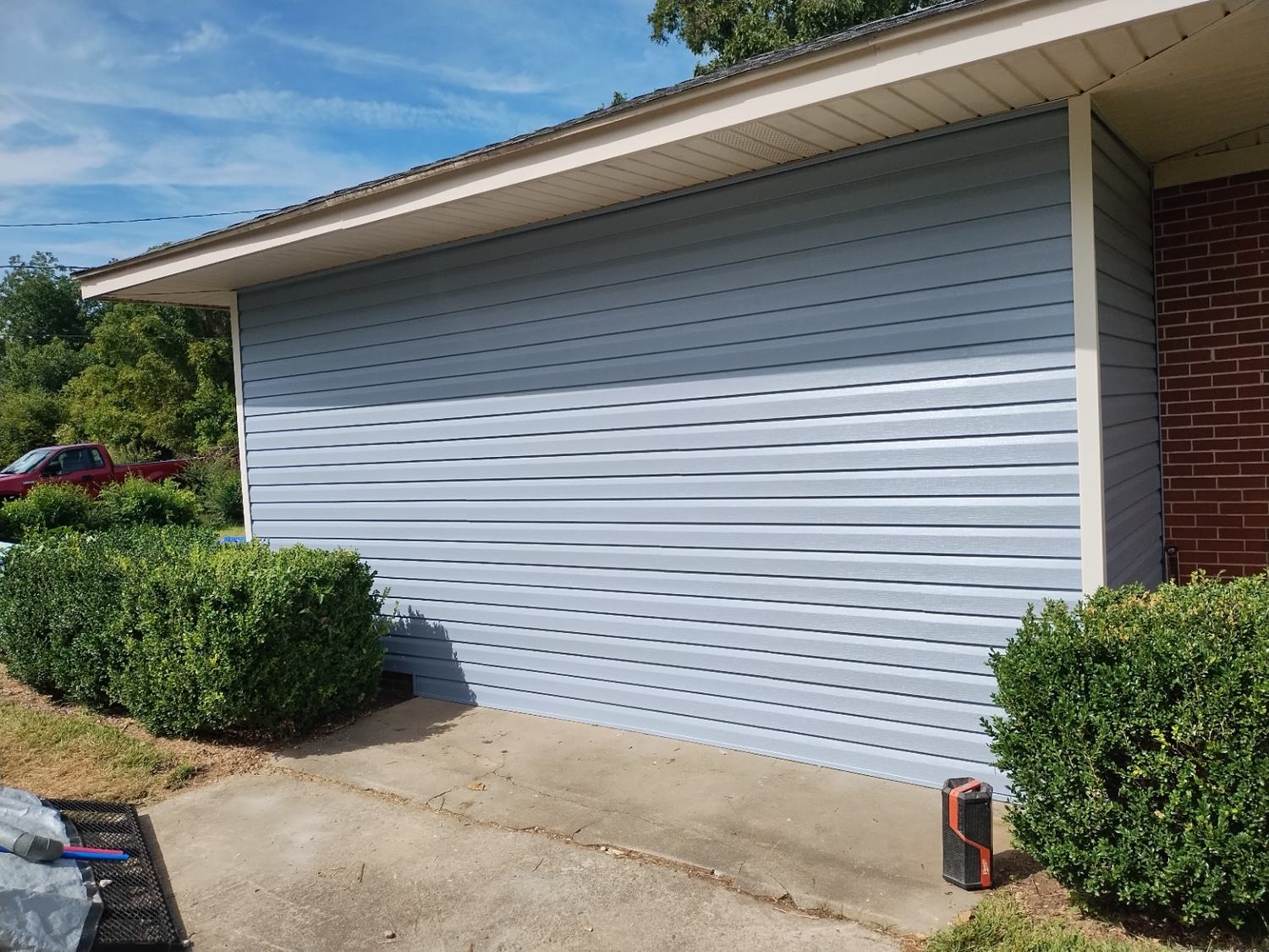 Completed exterior siding and trim finish work on the side of a home.